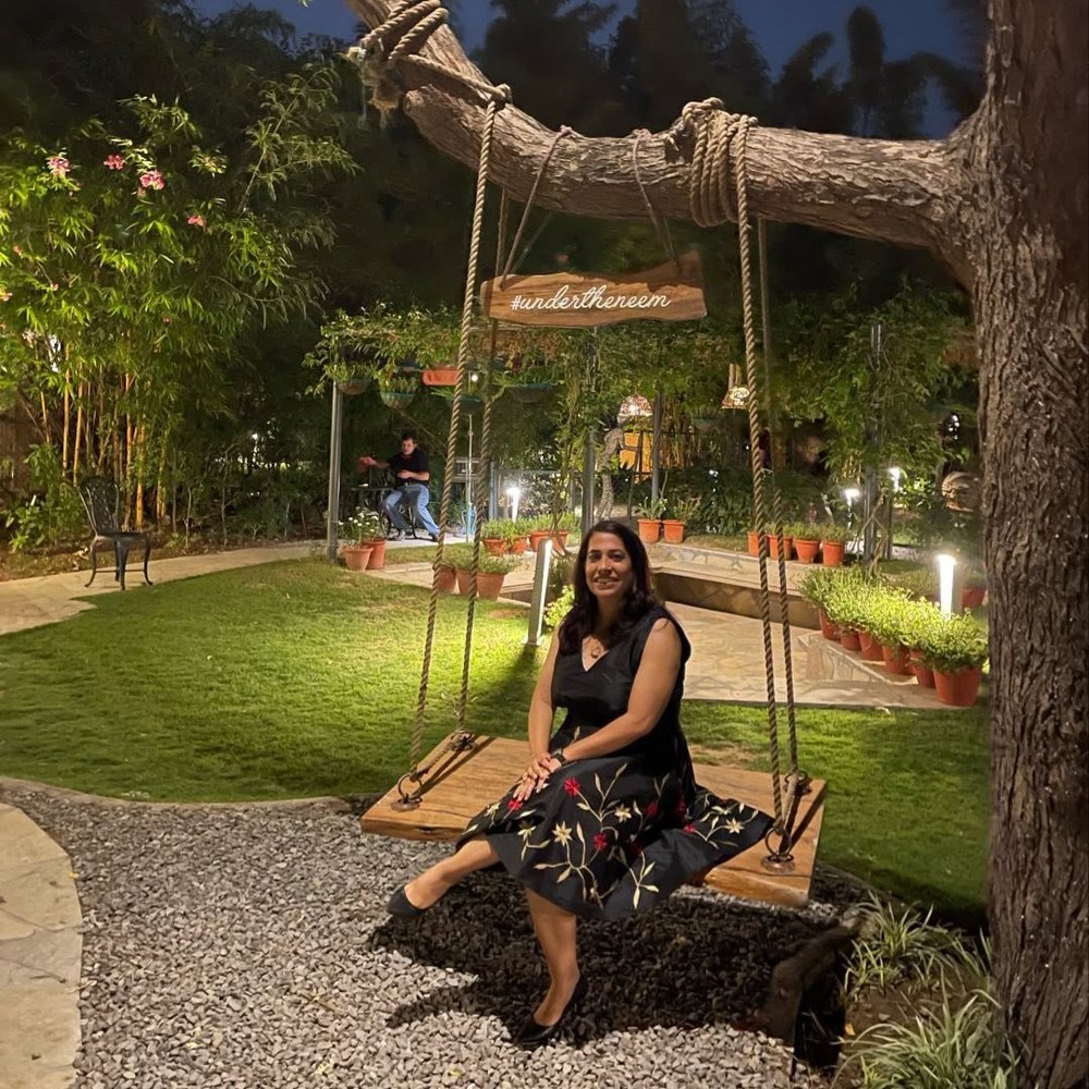 Ritika Angrish smiling outdoors in the evening